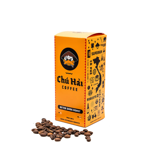 A box of Chữ Hai After Dark Roast coffee beans with a scattering of beans in front, against a white background